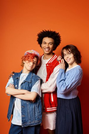 A group of young multicultural friends, including a nonbinary person, standing together in stylish attire in a studio setting.