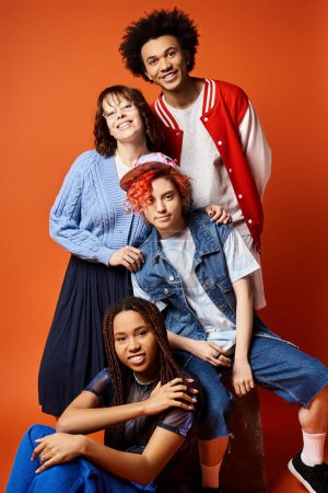 A diverse group of young friends, including a nonbinary person, posing stylishly for a group picture in a studio setting.
