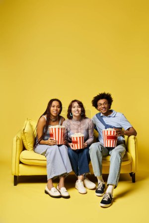Three diverse individuals relax on a couch, each holding a bowl of popcorn.