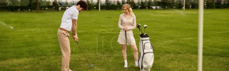 A young couple in elegant attire playing golf on a lush green field, enjoying their time together in a classy setting.
