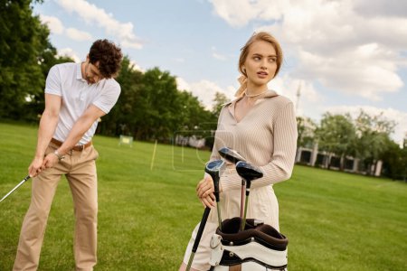 A young couple in elegant attire playing golf together on a green field at a prestigious club, embodying an upscale lifestyle.