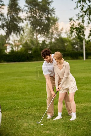 A man and woman in elegant attire play golf on a spacious green field at a prestigious country club.