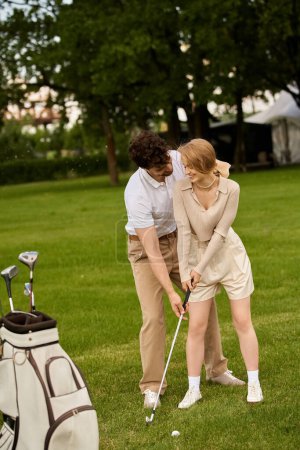 A young couple in elegant attire enjoying a game of golf on a sunny day at a prestigious golf club.