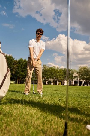 A stylish young couple plays golf on a lush green field, enjoying a day of outdoor leisure in elegant attire.