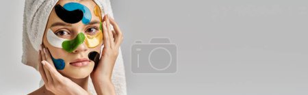 Photo for A young woman in a tranquil pose, sporting a towel turban on her head with eye patches on her face. - Royalty Free Image