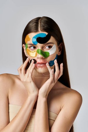 A beautiful young woman with eye patches on her face and hands, showcasing artistic expression and beauty.