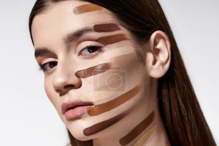 Téléchargez les photos : A beautiful young woman showcasing a vibrant array of makeup on her face. - en image libre de droit