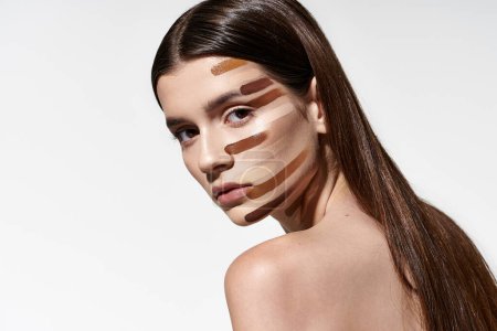 Foto de Attractive woman showcases her beauty with makeup on her face, including foundation. - Imagen libre de derechos