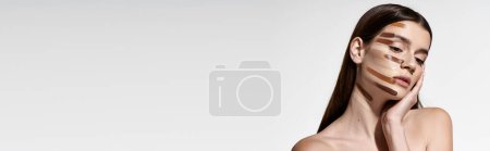 Photo for Chic young woman showcasing beauty products like foundation. - Royalty Free Image