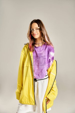 Teenage girl showcasing vibrant elegance in a yellow jacket and white pants, exuding style and confidence.