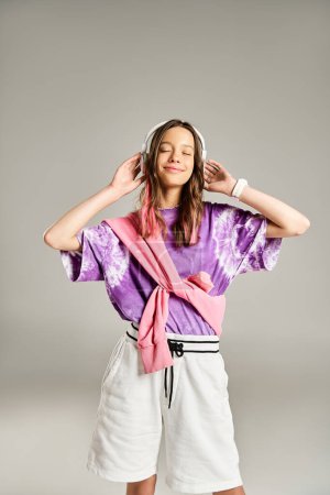 Photo for Stylish teenage girl in a purple shirt and white shorts striking a vibrant pose. - Royalty Free Image