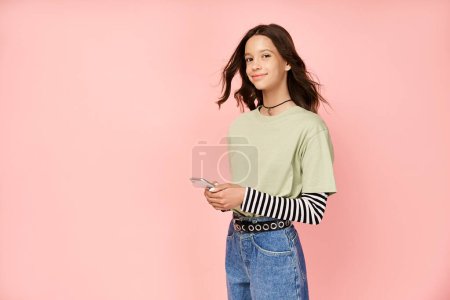 A stylish teenage girl poses confidently in front of a vibrant pink background.