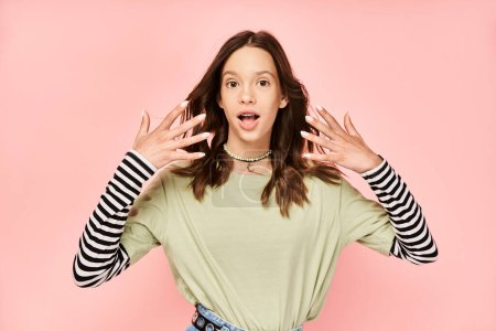 Photo for A vibrant, stylish teenage girl energetically raises her hands in the air with a look of pure joy and confidence. - Royalty Free Image