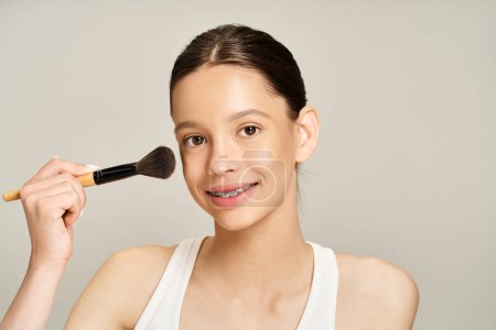 A stylish teenage girl in vibrant attire gently holds a brush to her face, showcasing an artistic and creative moment.