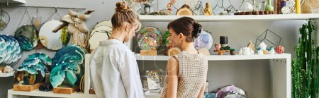 Two women, a loving lesbian couple, stand together in an art studio, showcasing their creativity.