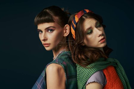 Photo for A beautiful lesbian couple with colorful makeup standing together. - Royalty Free Image