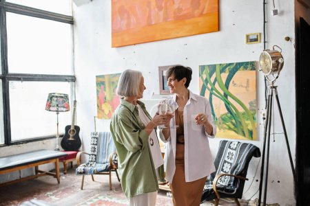 Photo for Mature lesbian couple standing in art studio. - Royalty Free Image