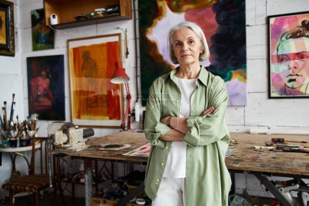 Foto de A woman standing in a room surrounded by exquisite paintings. - Imagen libre de derechos