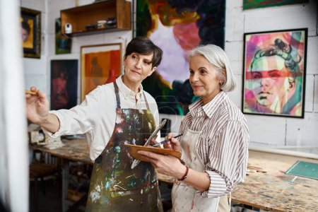 Two woman collaborating in an art studio.