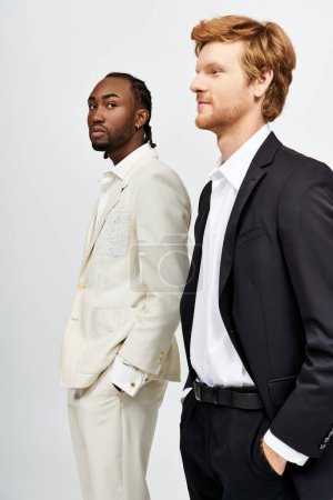 Photo for Two handsome multicultural men in suits standing side by side. - Royalty Free Image