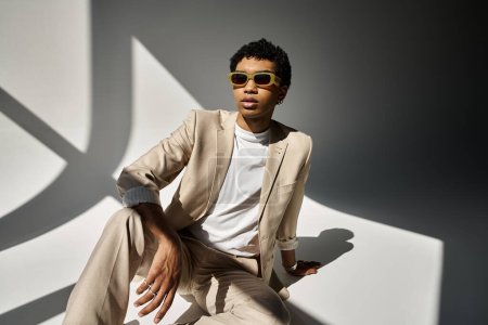 Handsome African American man in tan suit and stylish sunglasses.