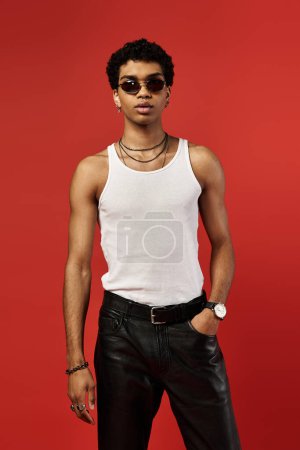Photo for Handsome man in white tank top and leather pants with stylish sunglasses. - Royalty Free Image