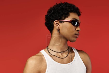 Young man in white tank top and shades.