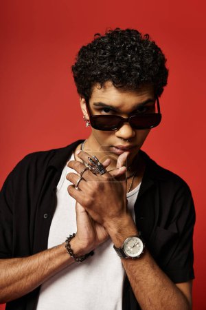 Handsome African American man sporting sunglasses and a watch.