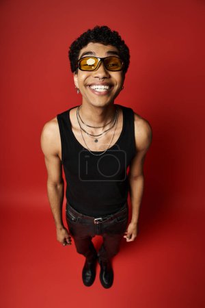 Handsome African American man wearing sunglasses and a black tank top.