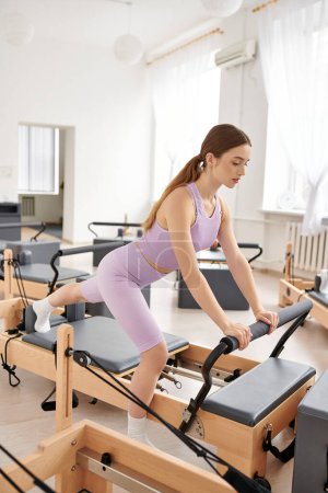 Woman exercising in gym, pilates.