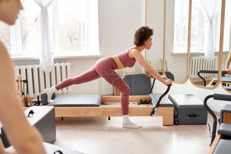 Two women exercising actively, pilates.