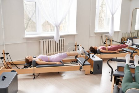 Two sporty women exercising in a serene room.