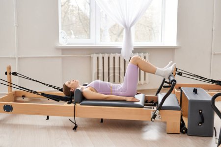 A sporty woman peacefully exercising in a serene room.