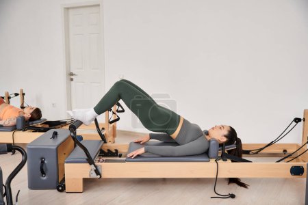 Asian sporty woman on a pilates lesson.