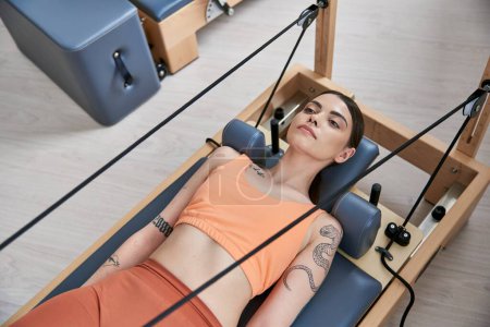 Alluring woman on a pilates lesson.