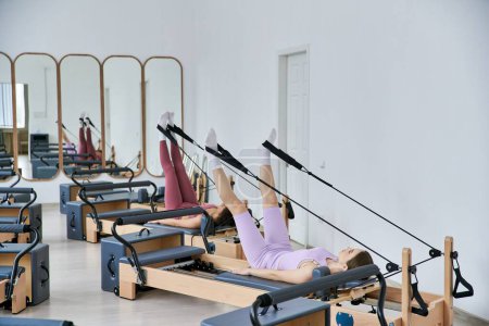 Fit women exercising during pilates lesson.