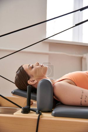 Photo for Young woman on a pilates lesson. - Royalty Free Image