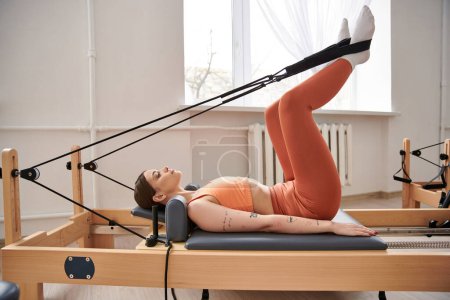 Photo for A sporty woman during a pilates lesson. - Royalty Free Image