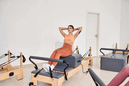 Alluring sporty woman practicing pilates with focus and determination.