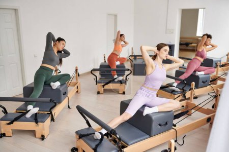 Sporty women practicing during a pilates lesson in a gym.