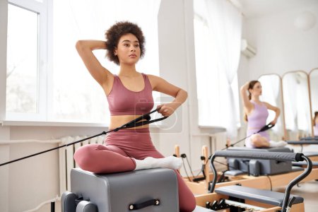 Beautiful women engage in a pilates class, focusing on flexibility and core strength.