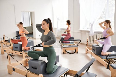 A group of sporty women practicing Pilates together.
