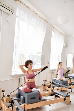 Photo for Sporty women engage in a pilates class, focusing on flexibility and core strength. - Royalty Free Image