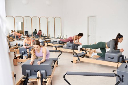 Active women engaging in a pilates session in a gym.
