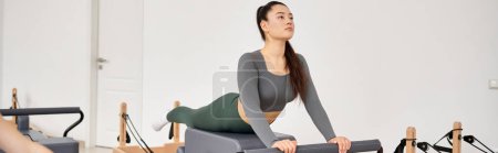 Beautiful woman exercising during a pilates lesson.