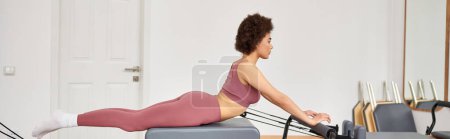 Attractive woman exercising during a pilates lesson.