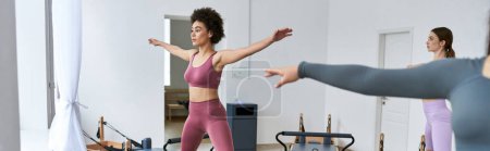 Photo for A group of pretty, sporty women practicing pilates in a serene room. - Royalty Free Image