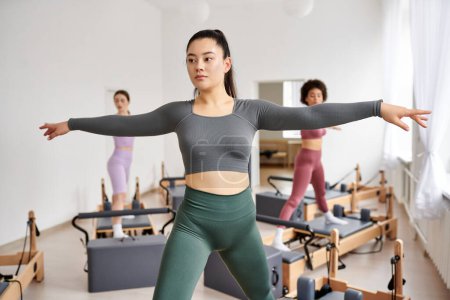 Sporty women engaging in a dynamic Pilates class.