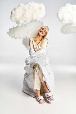 A dreamy blonde woman in cozy pajamas sits peacefully amid fluffy clouds.