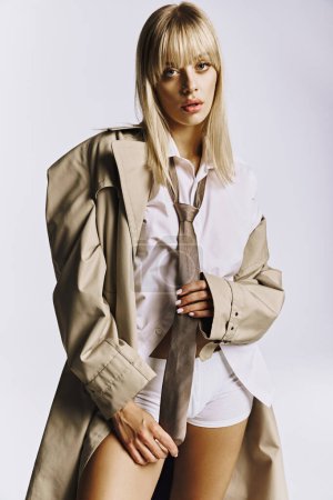 A stylish woman strikes a pose in short shorts and a trench coat.